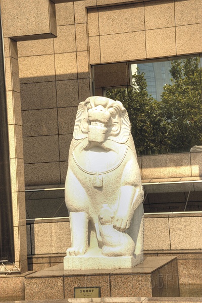 sh88.jpg - This statue is outside the museum of China.  It really looks like someone from Disney carved it.