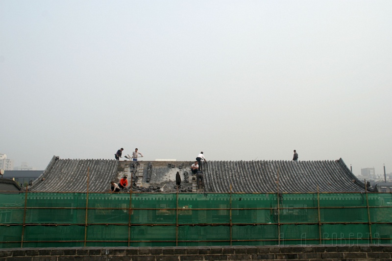 x6.jpg - Here we see workers constructing a traditional tiled roof.  This was the first time in my life I saw a woman roofer.  She is on the left front.