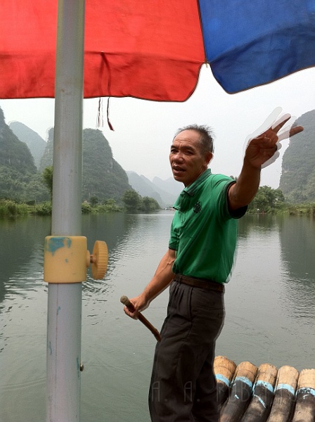 ys9.jpg - This was our river ride guide.  We gave the dude a few beers on the way down and the ride got much more fun.  He was singing to us and whooping it up over the rapids and giving us his x rated interpretation of what the hills looked like... in chinese...