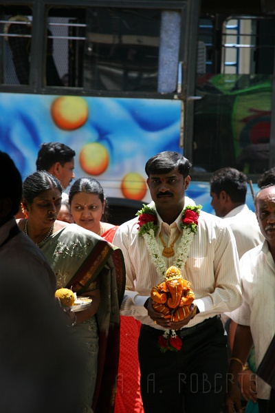 IMG_4987.JPG - Here the lucky guy!  That's a plushy Ganesh he's holding.  Ganesh is a Hindu god who has an elephant's head and a man's body.  He's very popular and his image can be seen everywhere.