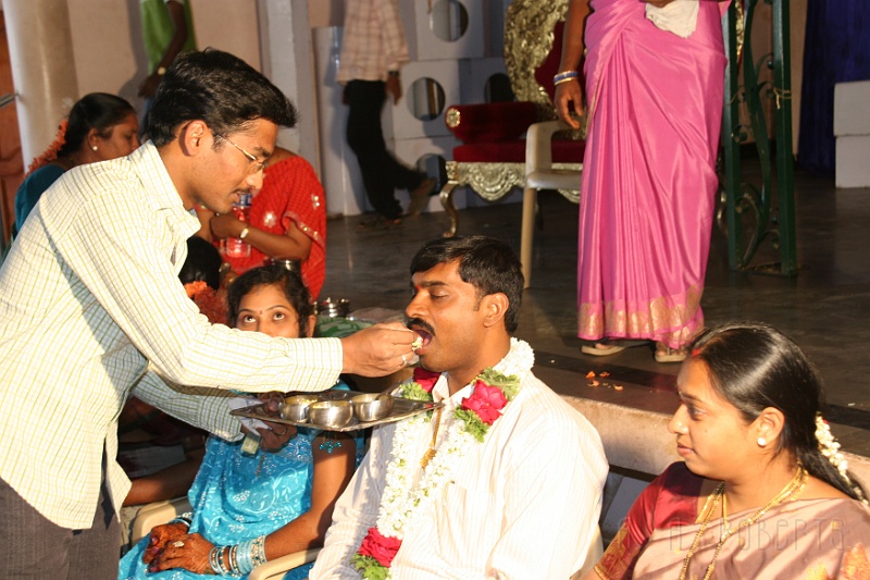 IMG_5048.JPG - Here the brides brother is feeding the Groom by hand. This is a token of love and care and small snack to refresh him after the journey to the wedding.