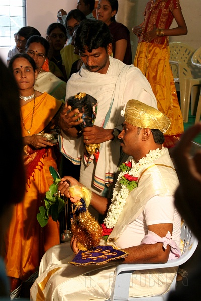 IMG_5259.JPG - The secondary priest is prepping the groom for the pilgramage (remember it's a pretend ceremonial pilgramage).